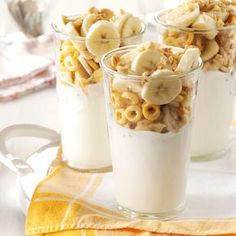 three cups filled with cereal and banana slices