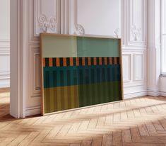 an abstract painting is displayed in front of a white room with wood flooring and walls