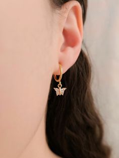 "These dainty earrings are made with cubic zirconia butterfly charms and 18 karat gold plated huggie hoops. This gold plating protects against wear and tear, tarnishing, and light contact with substances such as water. Closures: * Pierced gold hoops are hypoallergenic and nickel free (18 karat gold plated). * Clip on gold hoops are hypoallergenic and nickel free (18 karat gold plated). Dimensions: 0.87\" × 0.3\" How to wear clip ons: Hold the earring in one hand while pulling the closure open with the other hand, place the earring onto the thin upper earlobe, then slide the earring down the earlobe to secure in place. Please feel free to message me for any questions!"