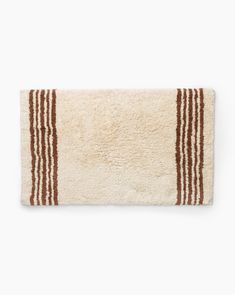 a white rug with brown stripes on the top and bottom, against a white background