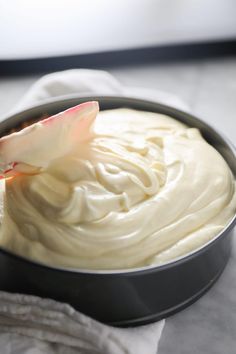 a metal pan filled with cream on top of a table