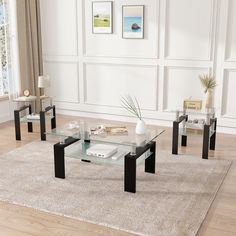 three glass tables sitting on top of a rug in front of a white wall and floor