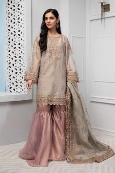 Pakistani gharara dress in lavish beige color with elegant zari embroidery. Net shirt is embellished with zari embroidery and tilla balls all over. Bottom of the dress and sleeves have been embellished with embroidered patches on net fabric. Trouser: Tissue fabric gharara in peach is added your fancy look for party or wedding event. Dupatta: Matching net dupatta is embellished with zari embroidery and shining lace on sides. Detailed Description: SKU: P2239 Detailing: Zari and tilla embroidery Co