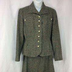 "A lovely lined women's suit by Fairbrooke--vintage 1940s or 1950s. Black and gray/white wool tweed with several secondary colors worked in, including teal, green, red, and orange. Interesting detailing on the chest, with smaller metal buttons that match the 7 buttons down the front. Spread-type collar; end of the jacket in front is curved, and the sleeves each have a small vent; 2 small pockets on either side. Jacket lining is sewn in all around; skirt lining is dark gray with pinked hem. There is no size tag, but I'm guessing this suit to be a small--make sure to see the measurements below! There is some staining and careful seam repair on the underarms--see last photo, Jacket measurements-- Underarm seam to underarm seam across back: about 18\" Waist: about 15.5\" Sleeve, from middle of Fitted Tweed Dress With Button Closure, Spring Fitted Wool Tweed Dress, Spring Wool Tweed Fitted Dress, Spring Wool Tweed Dress Fitted, Spring Wool Tweed Dress, Fitted Tweed Skirt Suit With Long Sleeves, Classic Fitted Tweed Dress With Button Closure, Classic Fitted Tweed Dress, Fitted Classic Tweed Dress With Button Closure