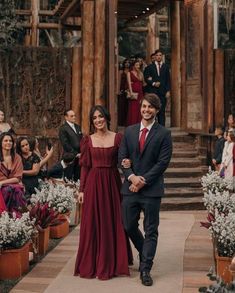 a man and woman are walking down the aisle