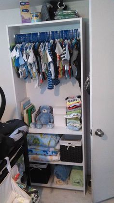 the closet is full of baby clothes and other things to put in it's storage area