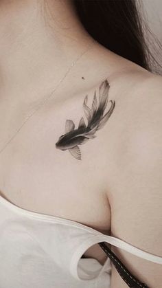 a woman with a feather tattoo on her chest