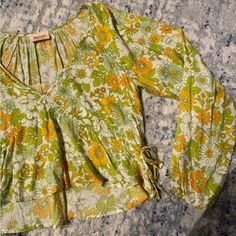 Colorful Green, Yellow And Orange Floral Blouse. Slightly Cropped With A V Neck. Flattering And So Cute For Spring. Never Worn In Great Condition, Fits True To Size. Retro Spring Beach Blouse, Vintage Green Blouse For Spring, Spring Yellow Floral Print Blouse, Yellow Floral Print Blouse For Spring, Vintage Spring Vacation Blouse, Mustard Long Sleeve Vacation Top, Vintage Flowy Spring Tops, Mustard Long Sleeve Top For Vacation, Vintage Flowy Tops For Spring