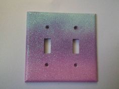 two pink and green lightshades on a white surface with holes in the middle