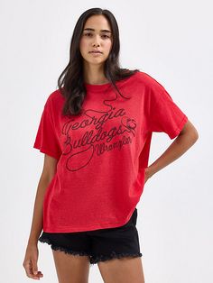 Comfort will win the day whenever you’re wearing the Women’s Wrangler® Collegiate Lasso Oversized Tee. This classic crewneck comes in your school’s color along with your team’s name and logo in lasso script lettering for a Western-inspired look and feel. An oversized fit makes it longer, looser, and more laidback. Plus, it’s crafted from a comfortable cotton blend you can wear from the first day of class to the final touchdown. Oversized School Spirit Tops For Campus, Cotton Campus Tops With Team Name, Relaxed Fit Logo Print Tops For Campus, Collegiate Tops For Sports Season On Campus, Cotton Tops For Campus During Sports Season, Campus School Spirit Tops With Text Print, School Spirit Graphic Print Tops For Campus, Collegiate Style Soft-washed Tops For Streetwear, School Spirit Tops With Text Print For Campus