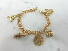 "FOR SALE IS A WOMENS VINTAGE ESTATE 14k GOLD CHARM BRACELET. THE BRACELET WEIGHS 25.4g, AND MEASURES 7\" LONG. THREE OF THE CHARMS ARE MARKED 14K. THE CROWN IS MARKED \"9K\", AND THE BELL CHARM IS 10K BUT NOT MARKED. ANY QUESTIONS PLEASE DON'T HESITATE TO ASK. THIS MAKES A GREAT GIFT FOR THAT SOMEONE SPECIAL. BE SURE TO CHECK OUT SOME OF MY OTHER GREAT ITEMS UP FOR SALE. THANK YOU." Antique Gold Bracelet Stamped 14k, Antique 14k Stamped Gold Bracelet, Vintage Gold-tone Gold-plated Bracelet, Vintage Gold-plated Jubilee Bracelet, Vintage Gold Plated Jubilee Bracelet, Gold Vintage Charm Bracelets For Wedding, Gold Bracelets With Vintage Charm For Wedding, Vintage Gold Tarnish-resistant Bracelet, Vintage Gold-plated Yellow Gold Bracelet