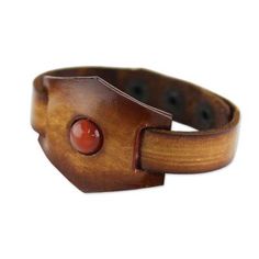 A bright and glossy carnelian stone sits boldly at the center of this rich leather bracelet. Thai artisan Chaloemphon hand-crafts the bracelet finishing it with three brass snap closures. Hand Tooled Adjustable Leather Bracelets, Brown Leather Strap Jewelry As Gift, Unique Adjustable Bracelet With Leather Strap, Brown Jewelry With Waxed Finish As Gift, Adjustable Leather Strap Bracelet, Brown Waxed Finish Jewelry As Gift, Unique Leather Bracelet Jewelry, Leather Bracelet Jewelry For Gifts, Vintage Leather Bracelet Jewelry