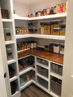 an organized pantry with lots of food in the shelves and bins on each side