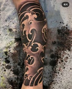 a man's leg with a tattoo on it and an ornate design in the middle