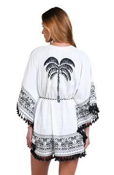 This black and white monochromatic print features an allover tropical motif perfect for any vacation destination. Tassel trim gives this cover-up a playful style that is at once carefree and put together. The square, belted front is offset by loose-fitting butterfly sleeves for a decidedly feminine silhouette. [split] Details Kimono cover-up Square, belted front Breezy butterfly sleeves Black/Ivory rope and black tassel trim Fabric 100% Polyester White Tie Waist Swimwear For Beach, White Swimwear With Tie Waist For Beach, White Summer Swimwear With Tie Waist, White Tie Waist Summer Swimwear, White Tie Waist Swimwear For Beach Season, White Swimwear With Tie Waist For Beach Season, White Tropical Print Swimwear As Beach Cover-up, White Cover-up For Resort Season, White Tropical Print Swimwear For Beach Cover-up