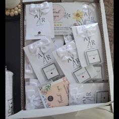 an open box filled with different types of wedding cards and tags on it's side