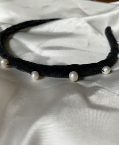 Feel like a queen with this velvet crown headband! Its intricate design is handmade from a velvet ribbon base and hand-stitched freshwater pearls on top to mimic the royal Queen's crown. This subtle statement accessory is perfect for an elevated everyday look or a memorable night out. Ideal gift to yourself or your loved female queen.   /KEY INFORMATION/  *Handmade; *Band width - 1 cm; *Stiff but flexible base;  *Soft inside; *One size band is suitable for all head sizes.  /OTHER INFORMATION/ All items are nicely and safely packaged for any occasion. I am a solo creator, I do everything handmade by myself - from idea to packaging everything is perfectly polished.  Have any questions? Don't hesitate to ask me! I am a creator I will be able to answer you anything :) See other velvet headband Black Handmade Headband, Queen Key, Velvet Crown, Adjustable Black Ribbon Headband, Hair Bands For Women, Velvet Padded Headband, Pearl Velvet Headband, Blue Velvet Padded Headband, Headband Wedding Hair