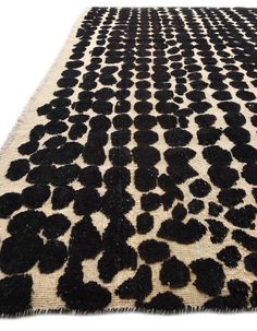 an animal print rug with black spots on it