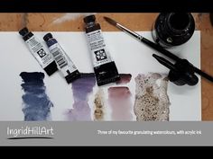 some watercolor paints are sitting on top of a piece of paper