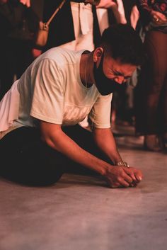 a man sitting on the ground looking at his cell phone