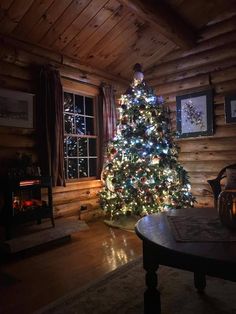 a living room with a christmas tree in the corner