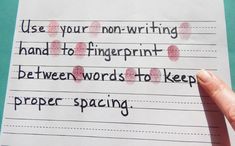 a hand holding up a piece of paper with writing on it that says use your non - writing hand to fingerprint between words to keep proper proper proper proper