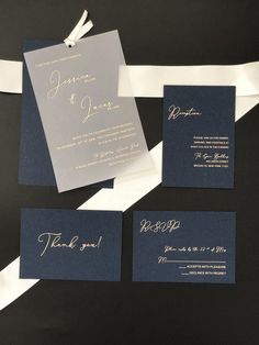 the wedding stationery is laid out on top of each other