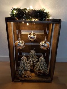 a wooden shelf with ornaments and lights on it