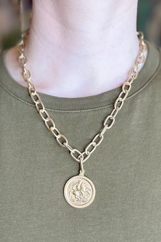 Make a statement with this matte-gold, chain necklace featuring a two-sided engraved coin pendant. Also makes a great addition to your layered necklace look. Lobster Clasp Closure. Length: 11.5" Metal Medallion Necklace With Gold Chain, Medallion Necklace With Gold Chain, Brass Medallion Necklace With Gold Chain, Gold-tone Metal Medallion Necklace With Coin Pendant, Gold-tone Medallion Coin Necklace, Brass Medallion Coin Necklace With Chain, Gold-tone Chain Necklace With Coin Pendant, Gold Collar Necklace, Layered Necklace