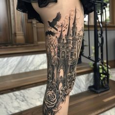 a woman's leg with a castle and roses tattoo on her left calf area