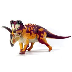 a small toy dinosaur on a white background