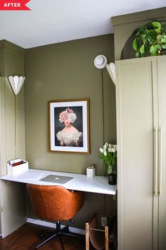 a desk with a laptop on it in front of a cabinet and flower vases