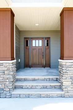 the front entrance to a home with steps leading up to it and two doors on each side