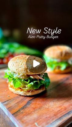 a close up of a sandwich on a cutting board with the words new style also party burgers