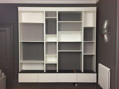 a white bookcase with many shelves in it