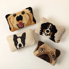 four decorative pillows with dogs on them