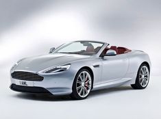 a silver sports car parked in front of a white background