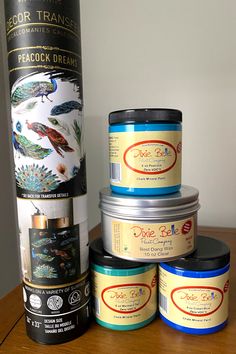 four jars of food sitting on top of a wooden table