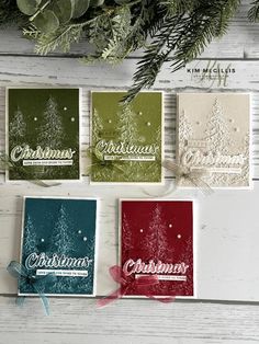 four christmas cards with pine trees on them