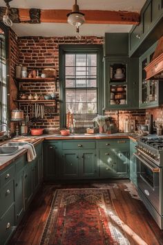 a kitchen with green cabinets and an area rug on the floor next to the stove