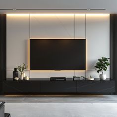 a living room with a large television on the wall and some plants in vases