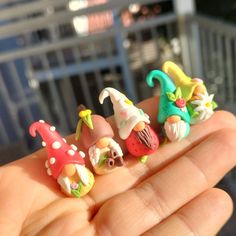 three miniature gnome figurines sitting in the palm of someone's hand