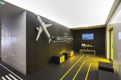 an airplane is on display in the airport lobby with yellow and black lines around it