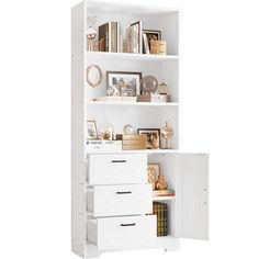 a white bookcase with drawers and pictures on it