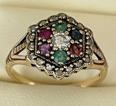 This is a Victorian Inspired DEAREST romantic ring which has been beautifully crafted from 9ct Solid Gold. A NATURAL Round Cut centre Diamond with surrounding outer frame LARGE 3mm diamond enhances the overall appeal. Emerald, Amethyst, Ruby, Sapphire and Tourmaline gemstones have been prominently set in a hexagonal face bringing this ring to life. THIS VICTORIAN INSPIRED ROMANTIC DEAREST RING IS TRULY AN EXQUISITE FINE JEWELLERY PIECE WHICH IS TO BE TREASURED FOR A LIFETIME ! * FREE GIFT BOX PR Dearest Ring, Victorian Multi-stone Ruby Ring For Wedding, Antique Multi-stone Ruby Ring, Victorian Multi-stone Ruby Ring, Unique Sapphire Rings, Victorian Multi-stone Ruby Ring Gift, Antique 14k Gold Ruby Ring With Multi-stone, Romantic Rings, Ring Vintage