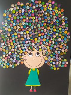 a child's artwork made out of buttons on a black board with a girl standing in front of it