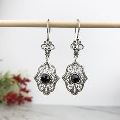 "Handmade Women's 925 Sterling Silver Dangle Drop Earrings with Genuine Black Spinel Gemstones Artisan Crafted Filigree Material: 925 Solid Sterling Silver Genuine Black Spinel Gemstones, 6 mm, Round, Faceted Earrings Length: 2 inches Width: 0.70\" Closure: Ear wire with safety catch Comes with a gift pouch and box Free Domestic Shipping Our handmade designer jewelry is unique in the world with its styling and quality. It is a gift that will create memories for years to come. For this particular