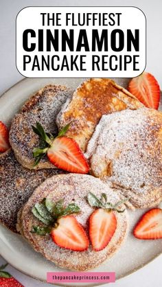 the flufflest cinnamon pancake recipe is topped with powdered sugar and fresh strawberries