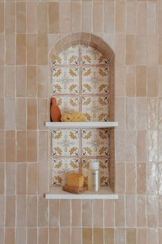 two shelves in the corner of a tiled wall with some food on top of them