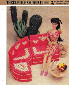 a crocheted table cloth with a doll sitting on it and cactus in the background